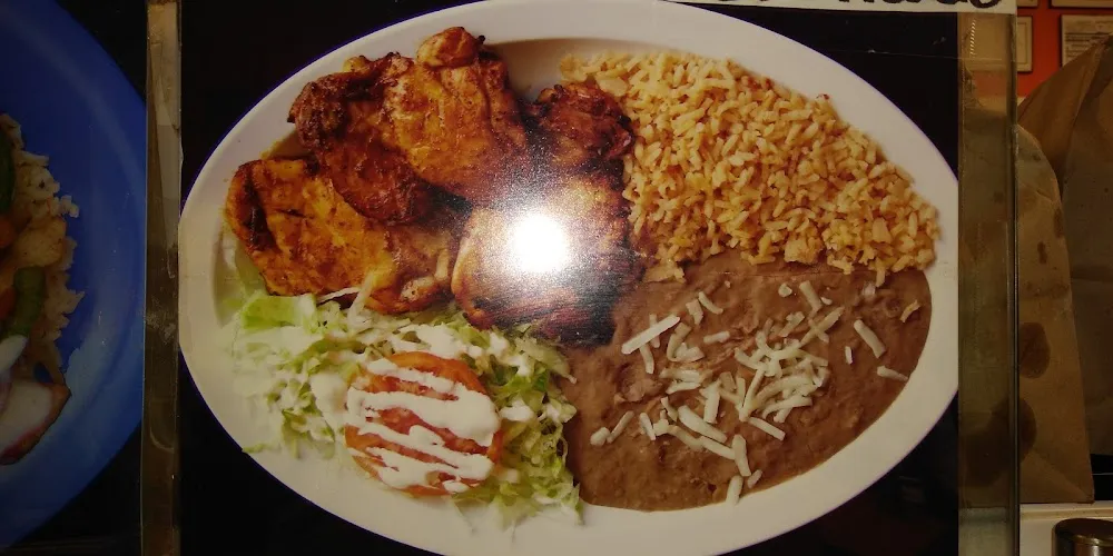 One Chicken Taco Rice Beans and a Drink